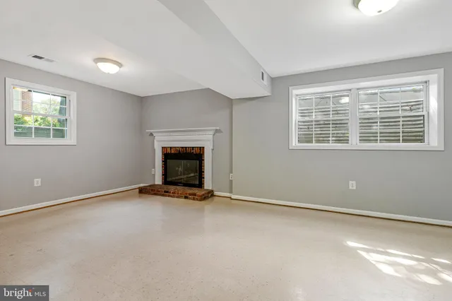 a view of an empty room with a fireplace
