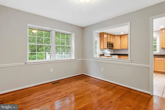 a view of a kitchen with wooden floor and electronic appliances