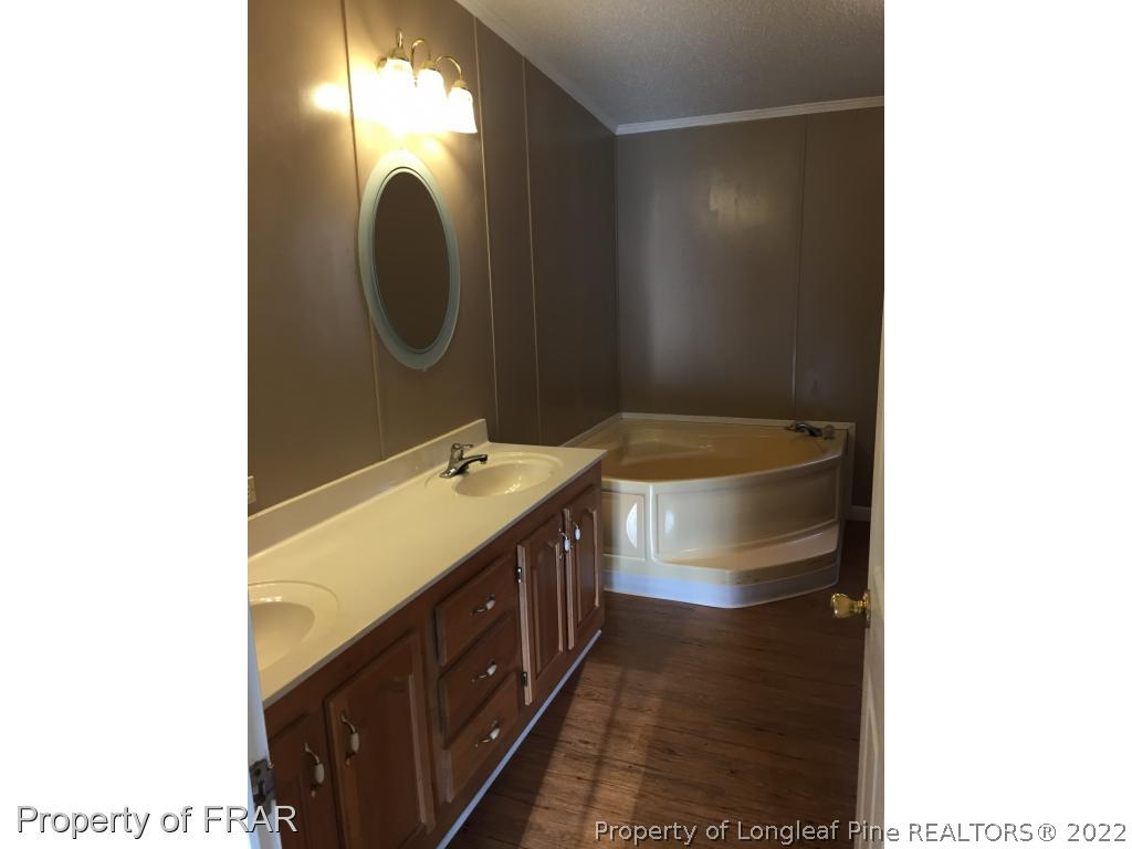 275 Deaton Road Raeford, NC 28376 - Photo 3 of 20 a bathroom with a double vanity sink and a mirror