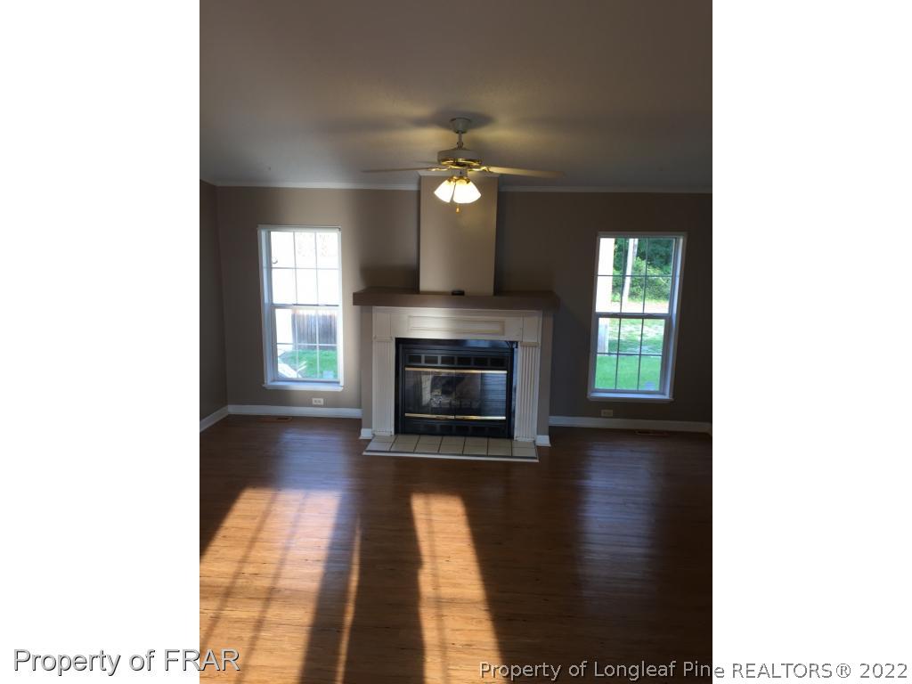 275 Deaton Road Raeford, NC 28376 - Photo 8 of 20 a view of a livingroom with a fireplace and a window
