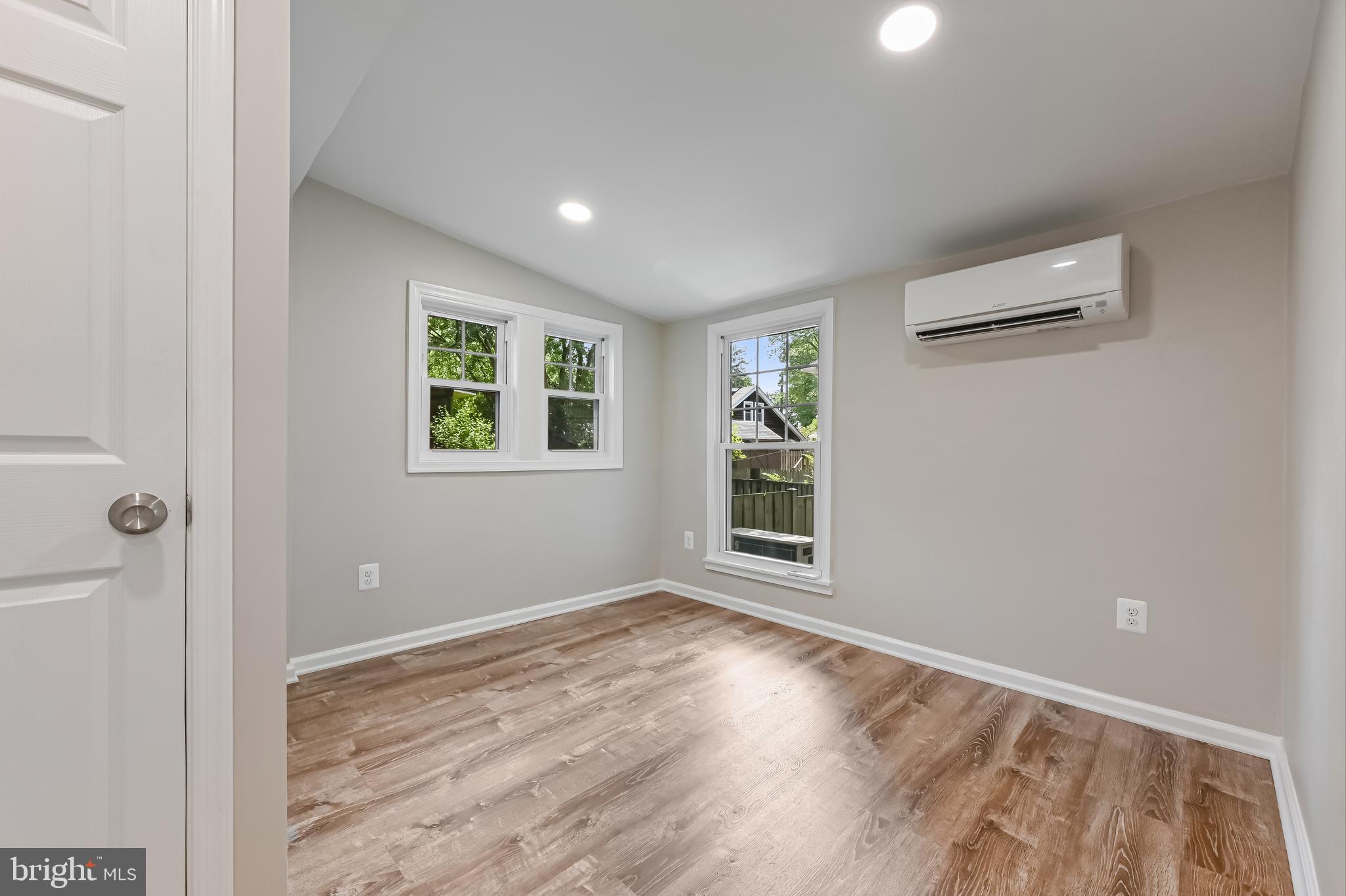 405 Bayview Drive Edgewater, MD 21037 - Photo 12 of 28 an empty room with wooden floor and windows