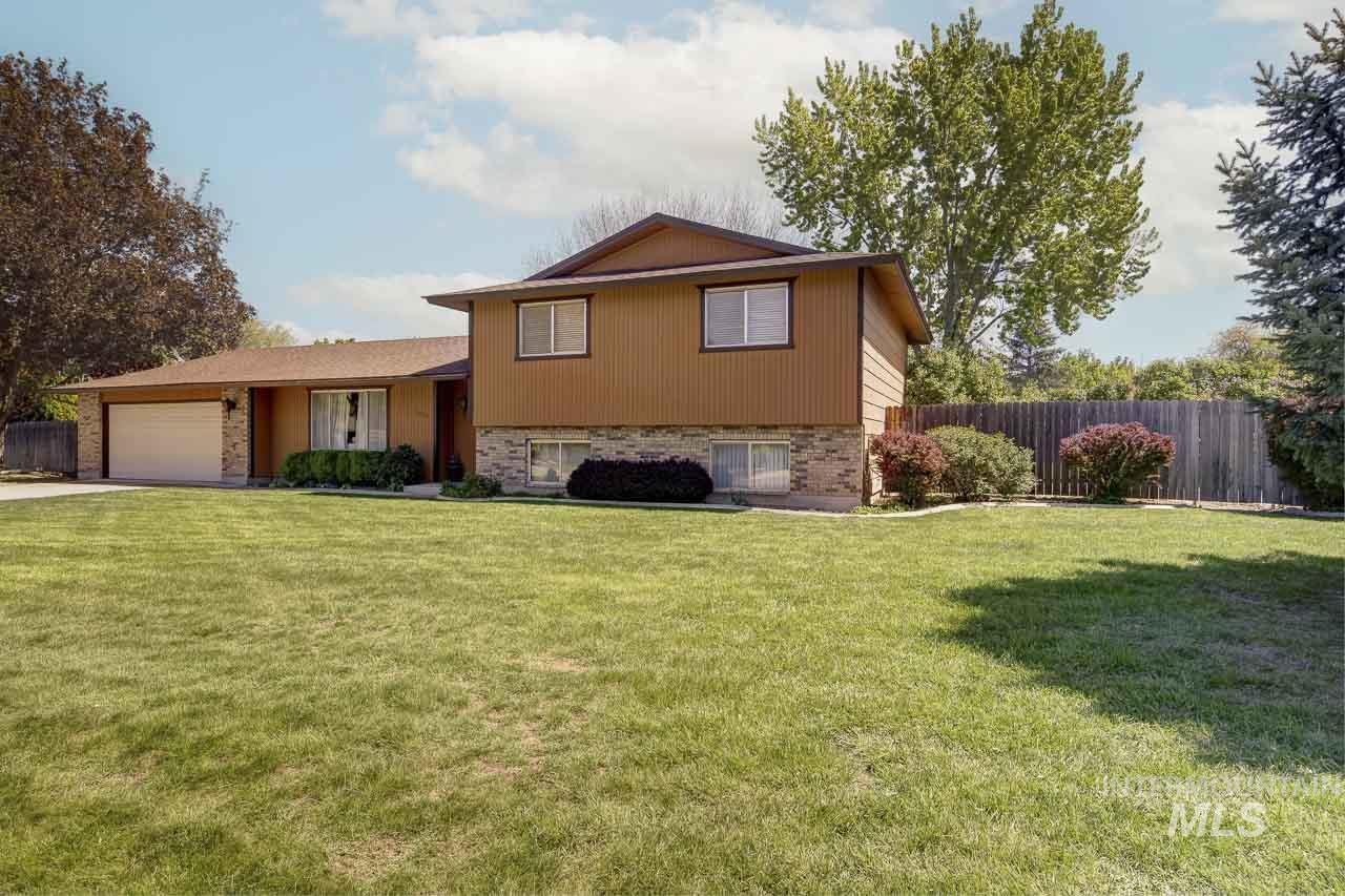 1954 Denell Way Boise, ID 83709 - Photo 1 of 1 Tri-level home featuring an attached garage, brick siding, and driveway