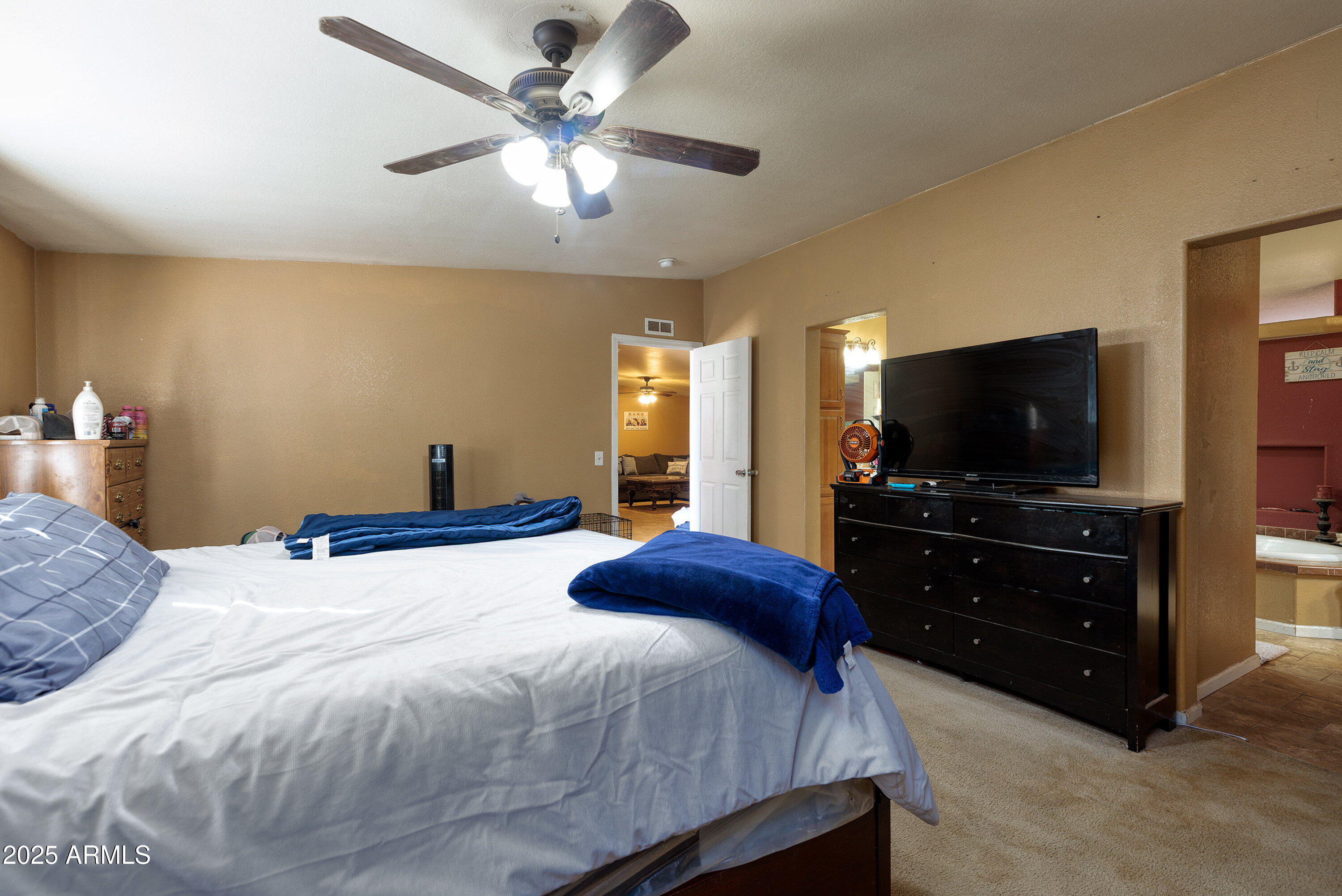 1008 West Rim View Road Payson, AZ 85541 - Photo 16 of 25 a bedroom with a bed and a flat screen tv