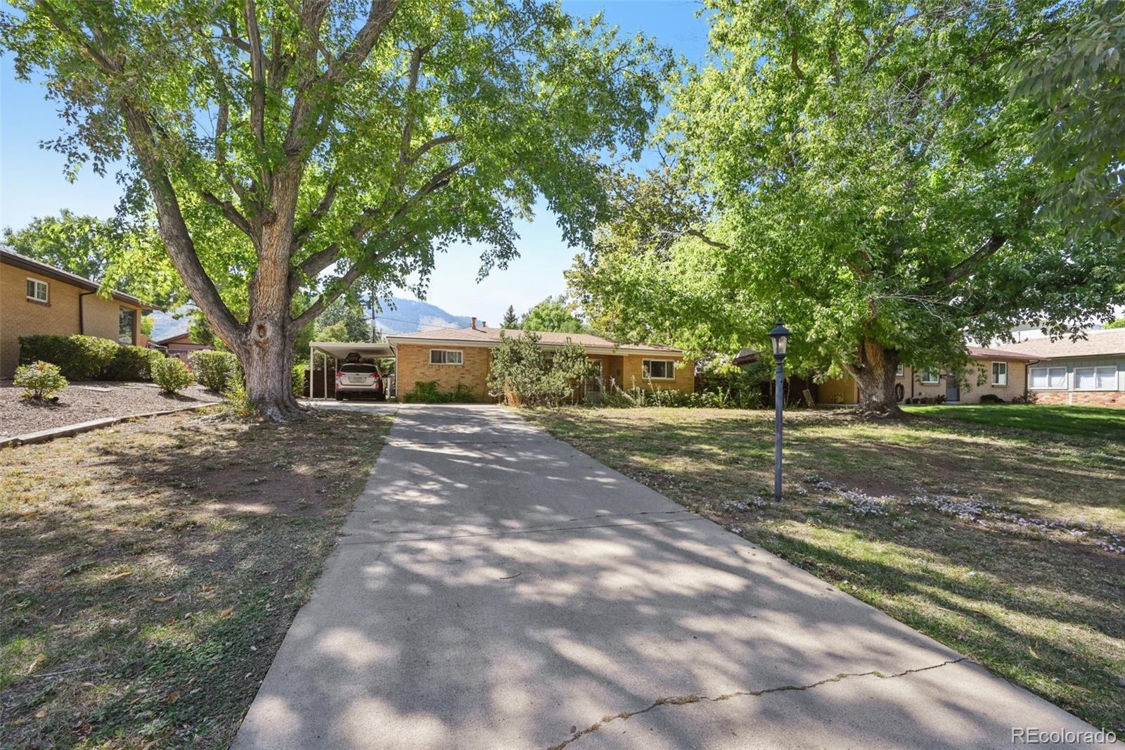 2114 Arapahoe Street Golden, CO 80401 - Photo 1 of 16 a view of a yard with plants and trees