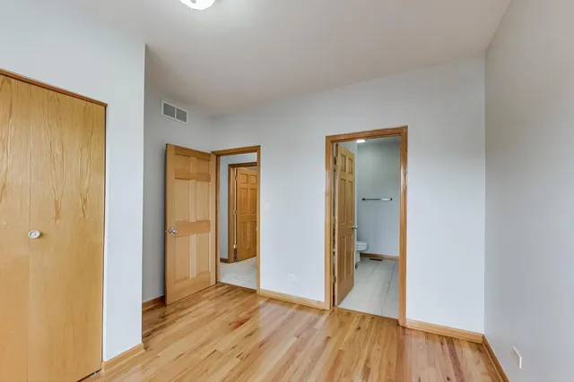 a view of hallway with wooden floor