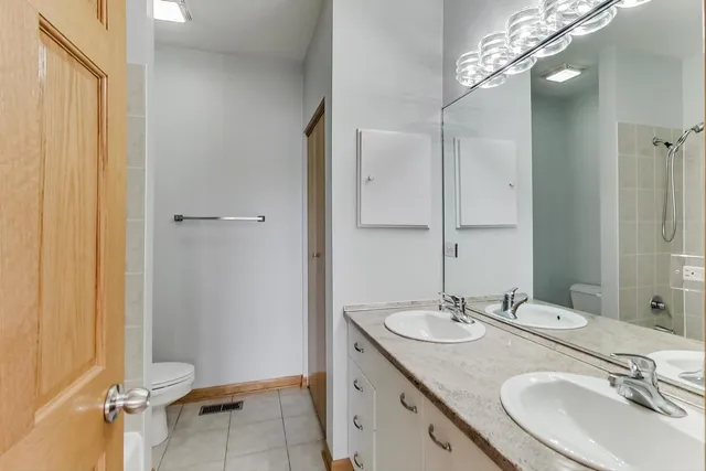a bathroom with a sink double vanity and a mirror