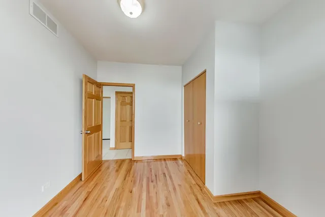 a view of a room with wooden floor and bathroom