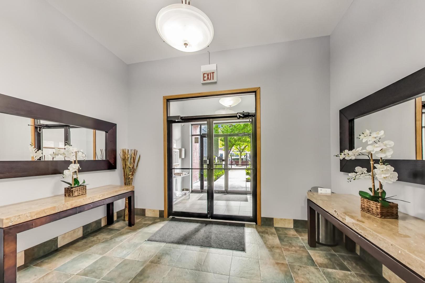 2032 West Division Street, Unit 201N Chicago, IL 60622 - Photo 5 of 18 a bedroom with furniture and a window
