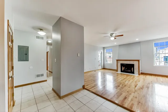 a view of a livingroom with a fireplace and window