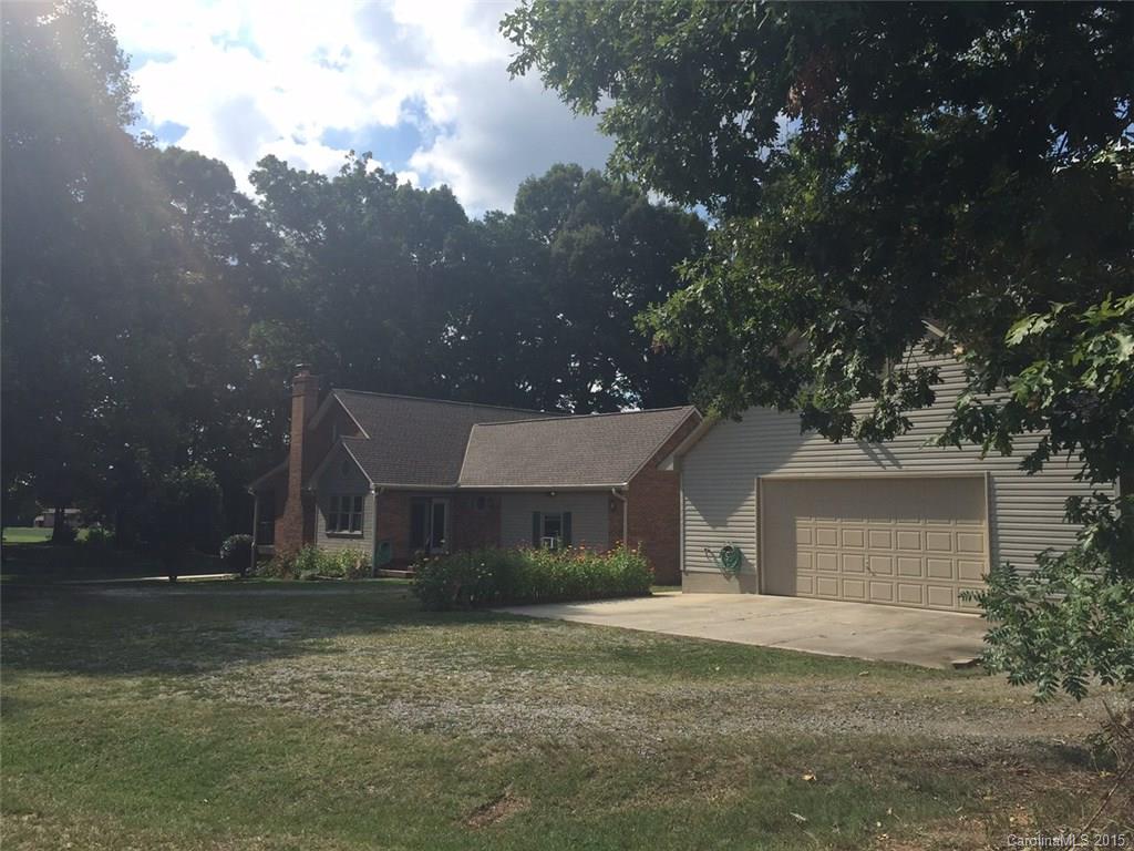 8018 Unity Church Road Kannapolis, NC 28081 - Photo 5 of 24 a front view of a house with a yard and garage