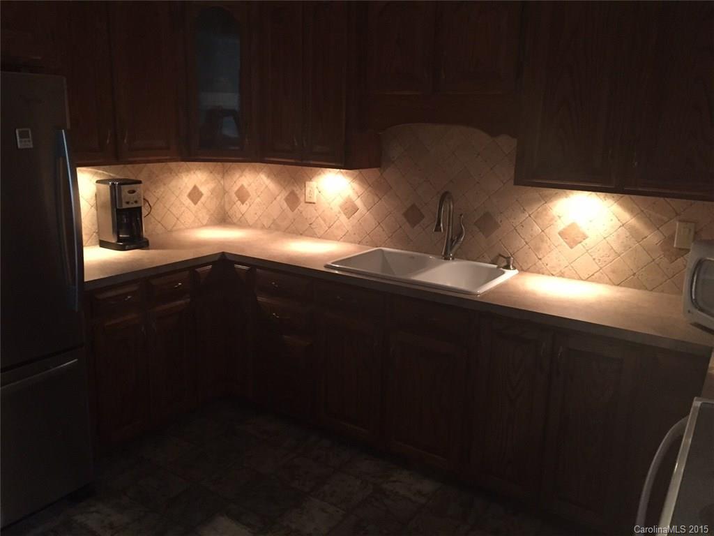 8018 Unity Church Road Kannapolis, NC 28081 - Photo 9 of 24 a kitchen with a sink a window and wooden floor