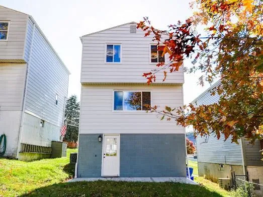 a view of house with yard