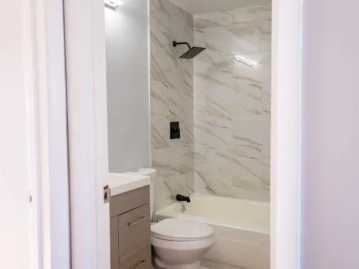 a bathroom with a toilet and a shower