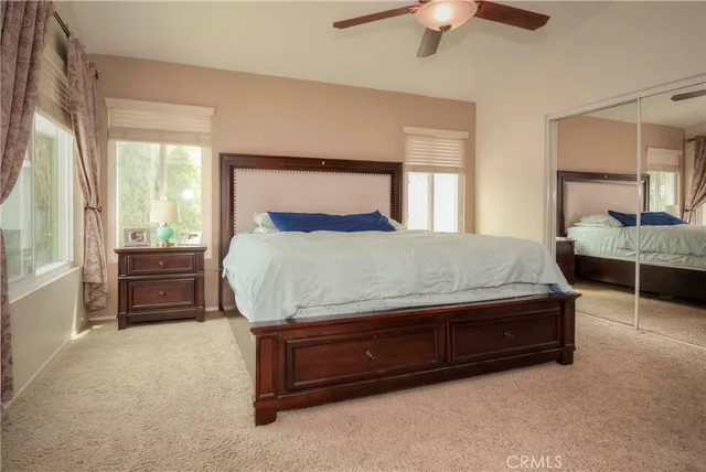 a bathroom with a toilet sink vanity and mirror