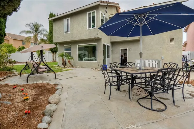 a view of a chairs and table in backyard