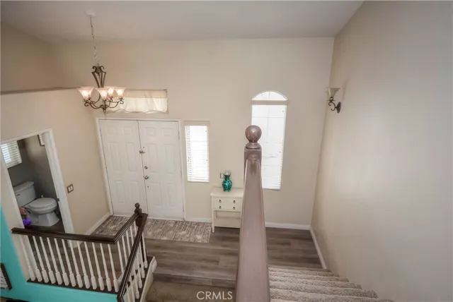 a view of a hallway view with wooden floor and staircase