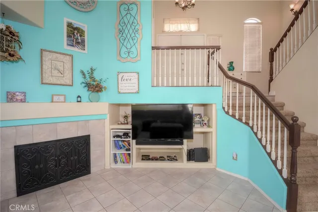 a living room with fireplace and a flat screen tv