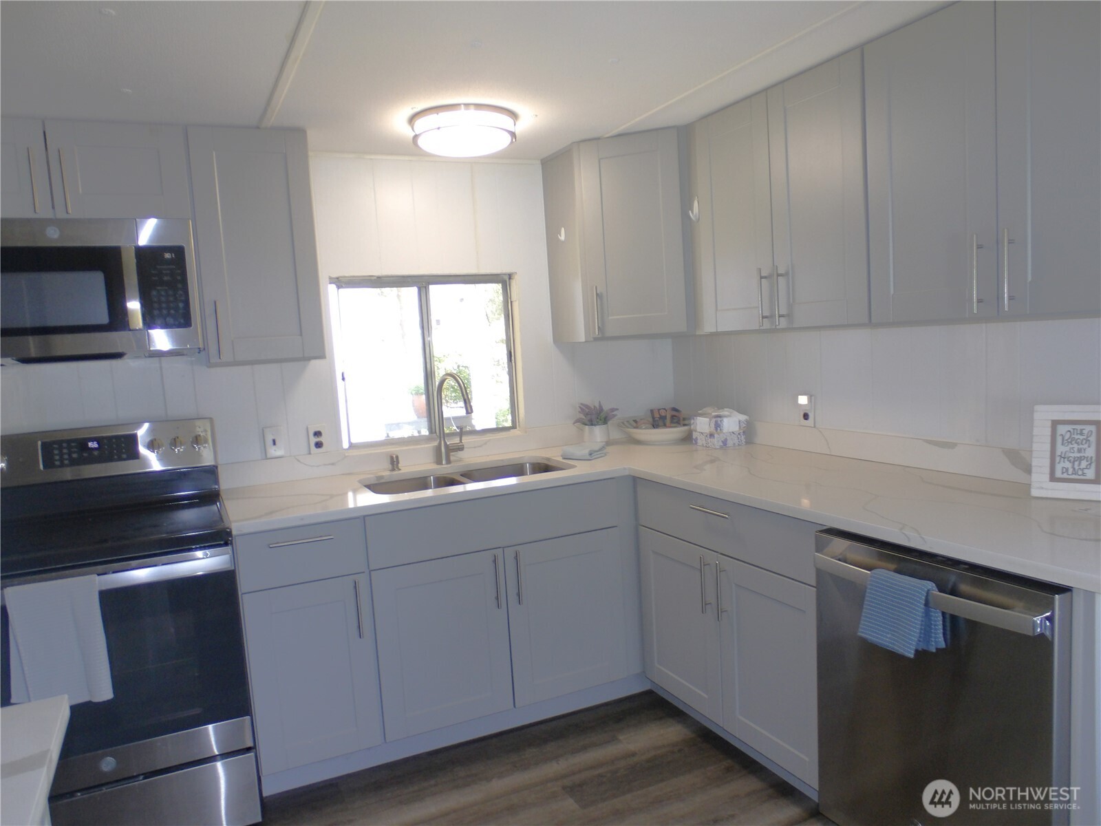 1308 263rd Place Ocean Park, WA 98640 - Photo 15 of 35 a kitchen with a sink cabinets and window