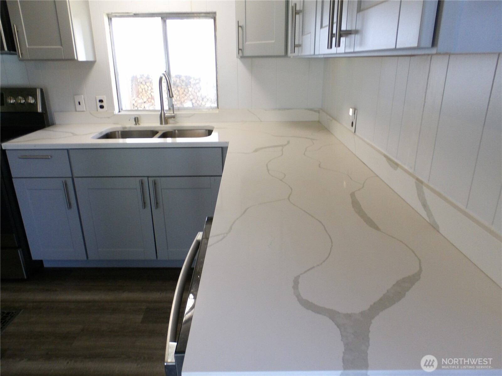 1308 263rd Place Ocean Park, WA 98640 - Photo 16 of 35 a utility room with a sink a washer and dryer