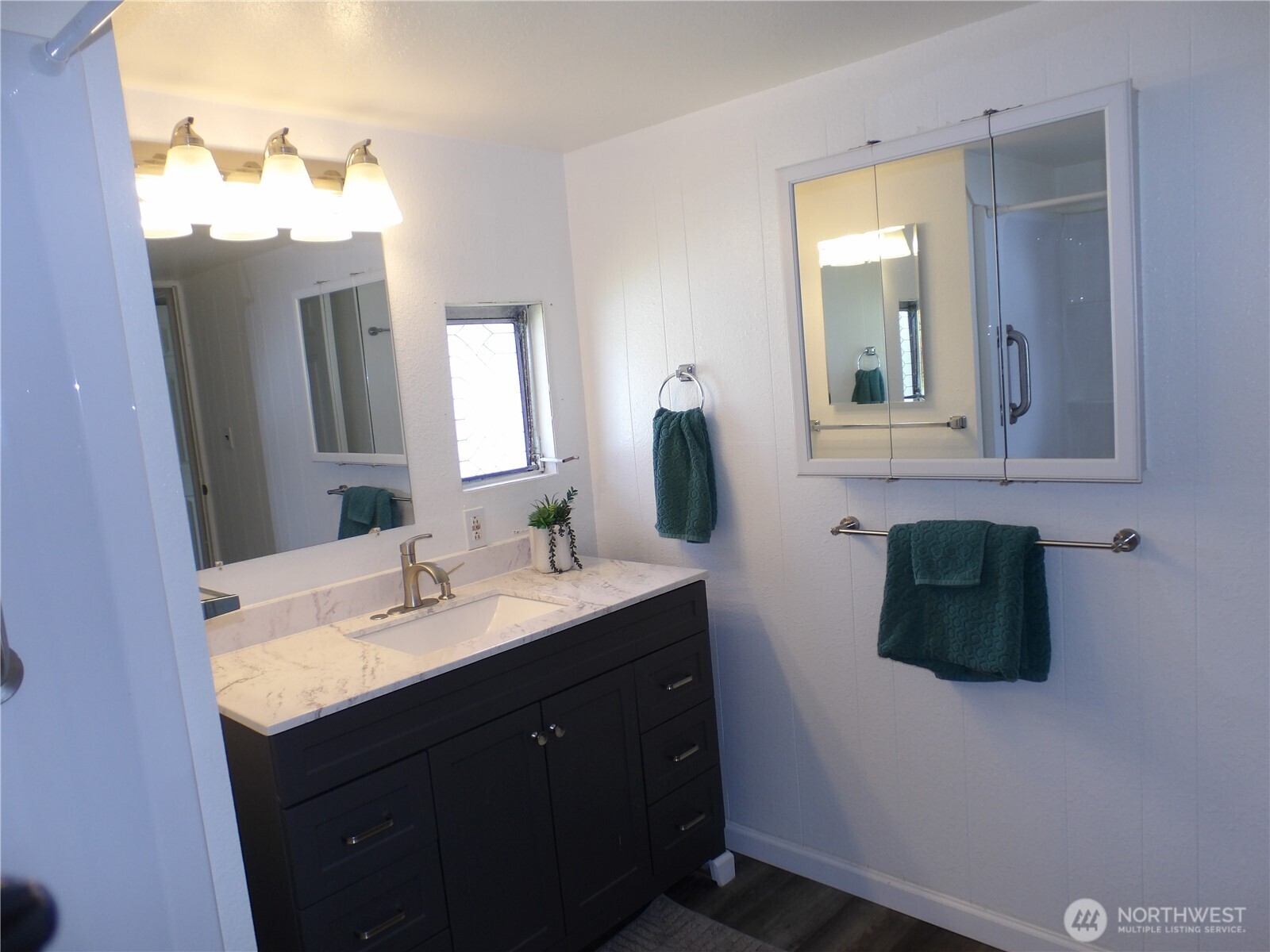 1308 263rd Place Ocean Park, WA 98640 - Photo 21 of 35 a bathroom with a double vanity sink and mirror