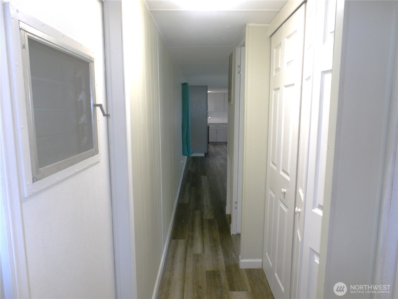 1308 263rd Place Ocean Park, WA 98640 - Photo 32 of 35 a view of a hallway with wooden floor and a bathroom