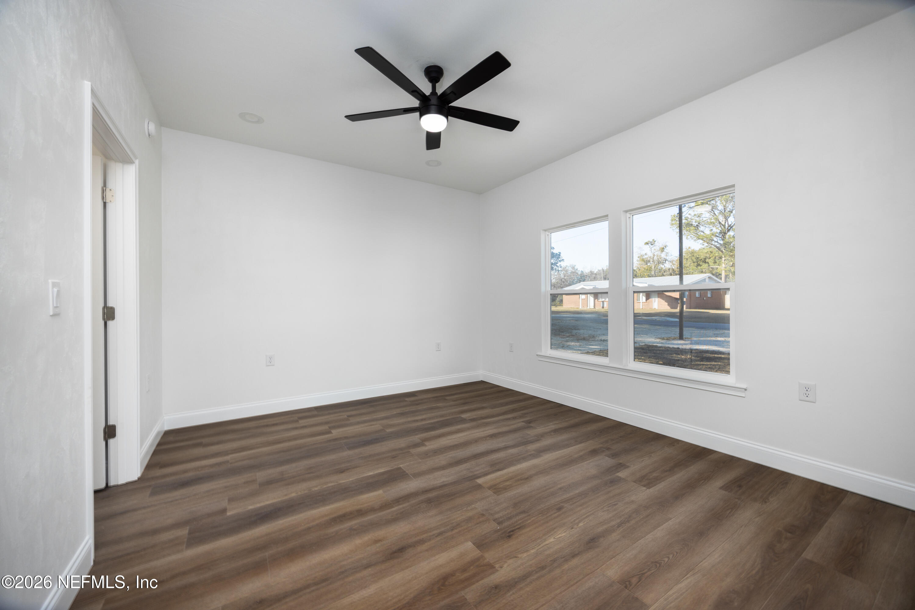 220 Southwest 3rd Street Lake Butler, FL 32054 - Photo 12 of 40 wooden floor in an empty room with a window