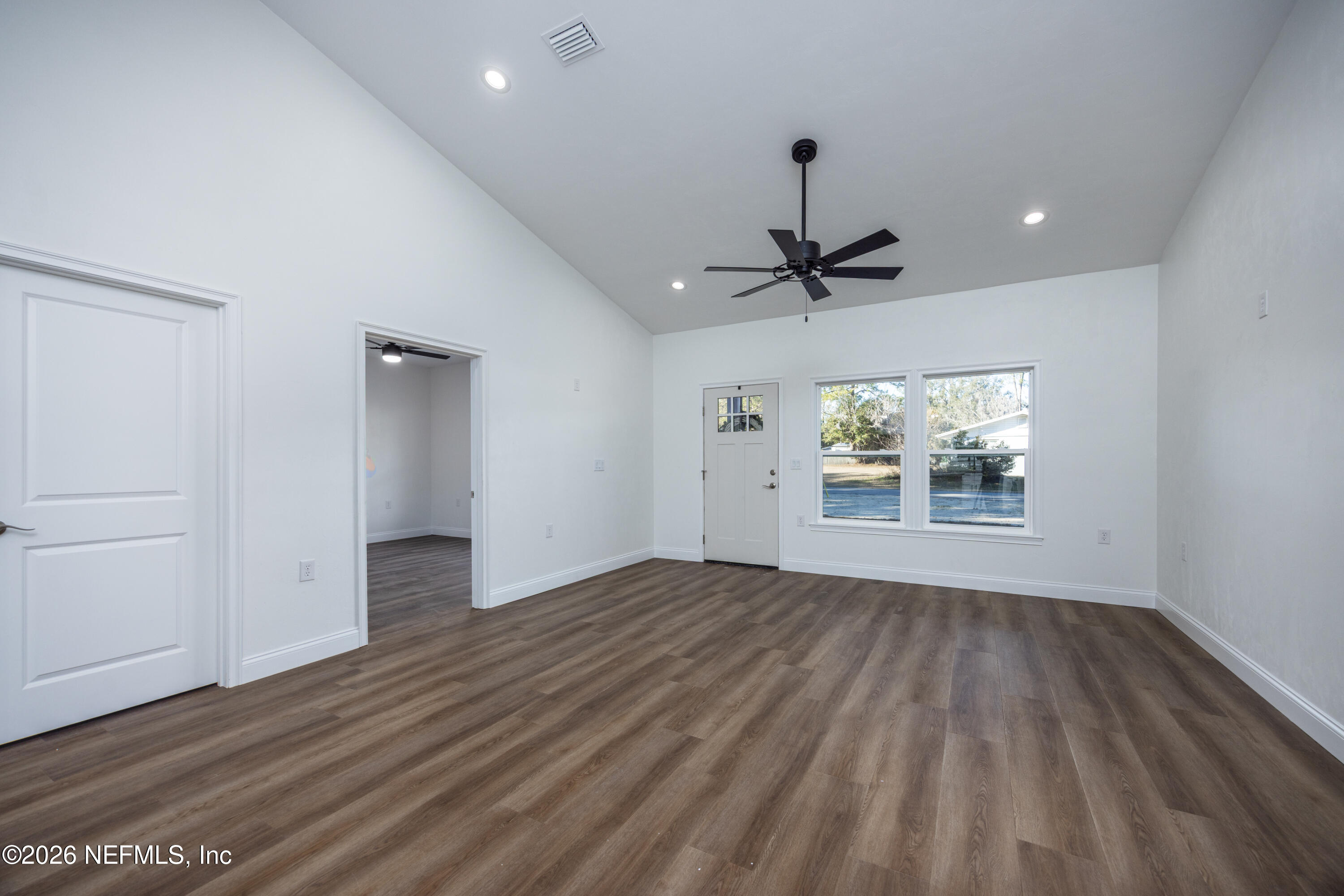 220 Southwest 3rd Street Lake Butler, FL 32054 - Photo 32 of 40 a view of an empty room with a window and wooden floor