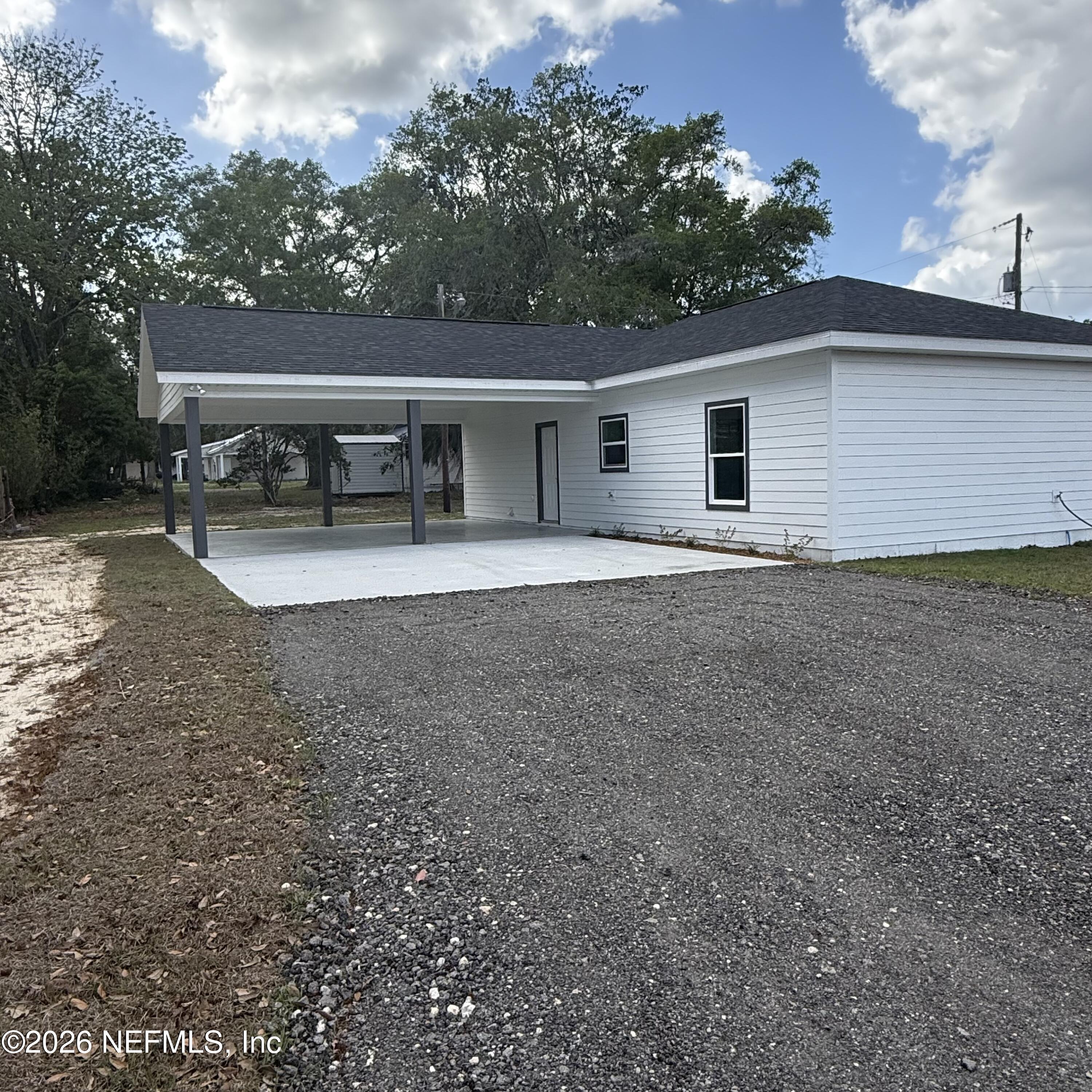 220 Southwest 3rd Street Lake Butler, FL 32054 - Photo 48 of 48 a front view of house with yard and trees in the background