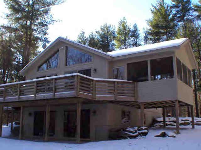 106 Harrington Road Otis, MA 01253 - Photo 2 of 5 a view of a house with a garage