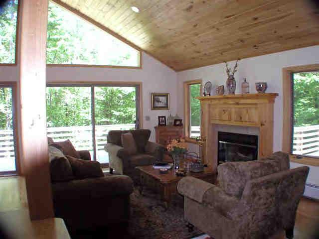 106 Harrington Road Otis, MA 01253 - Photo 4 of 5 a living room with furniture a fireplace and a large window