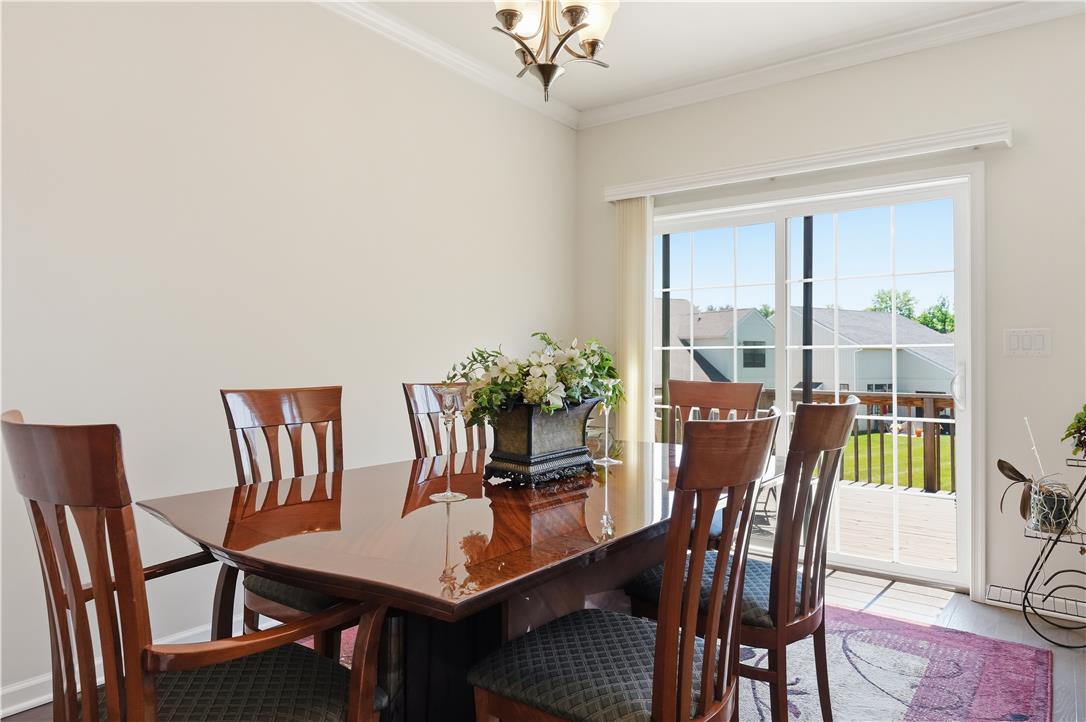 4120 Eveningstar Road Emmaus, PA 18049 - Photo 18 of 62 A lustrous dining table and chairs are bathed in natural light, offering outdoor access.
