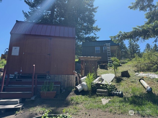 175 Ellemeham Road Loomis, WA 98827 - Photo 5 of 11 a view of a backyard with plants and a fountain