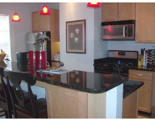 225 Carpenter Street, Unit 2 Providence, RI 02903 - Photo 2 of 9 a kitchen with stainless steel appliances granite countertop a sink dishwasher and cabinets with wooden floor