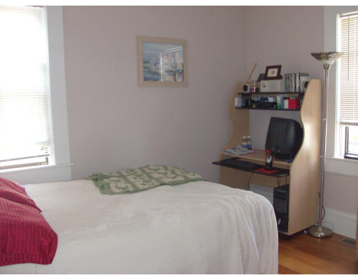 225 Carpenter Street, Unit 2 Providence, RI 02903 - Photo 6 of 9 a bedroom with a bed and cabinets