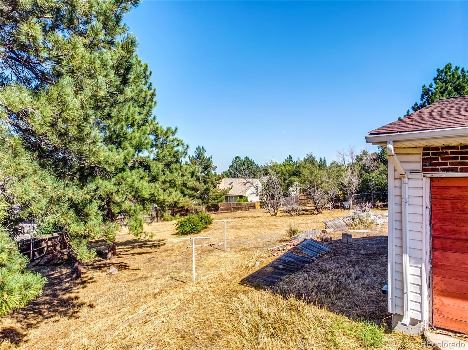 6766 Zenobia Loop Arvada, CO 80030 - Photo 15 of 38 a view of a yard with an tree