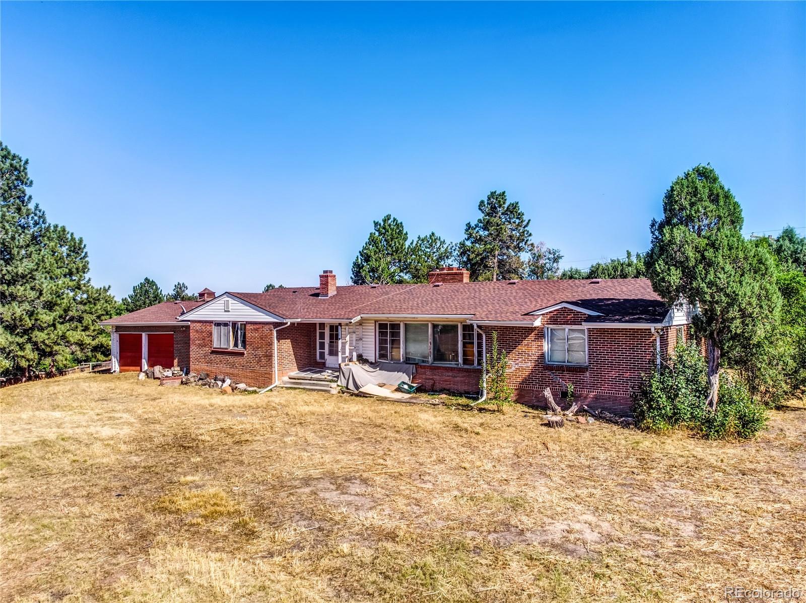 6766 Zenobia Loop Arvada, CO 80030 - Photo 2 of 38 a front view of a house with a yard