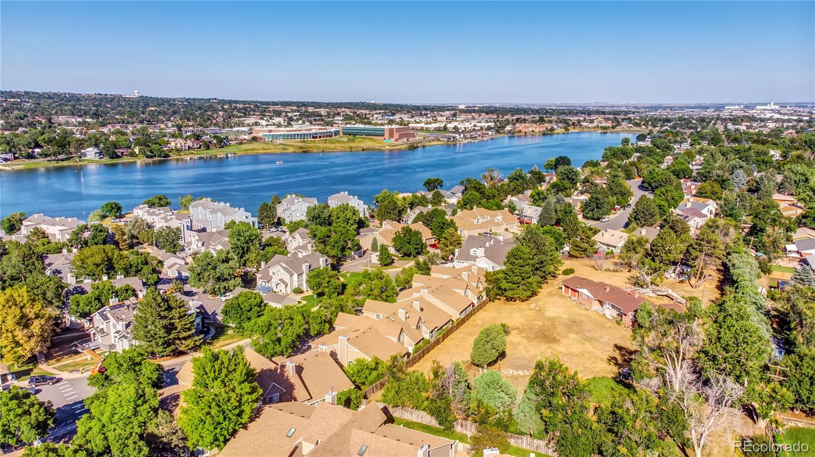 6766 Zenobia Loop Arvada, CO 80030 - Photo 24 of 38 view of a lake with houses