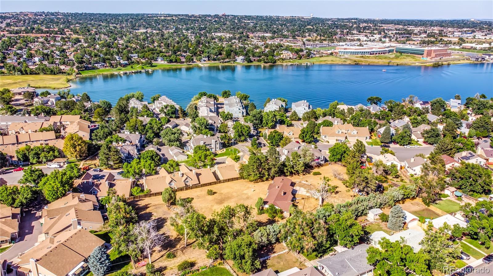 6766 Zenobia Loop Arvada, CO 80030 - Photo 25 of 38 an aerial view of a houses with a lake view