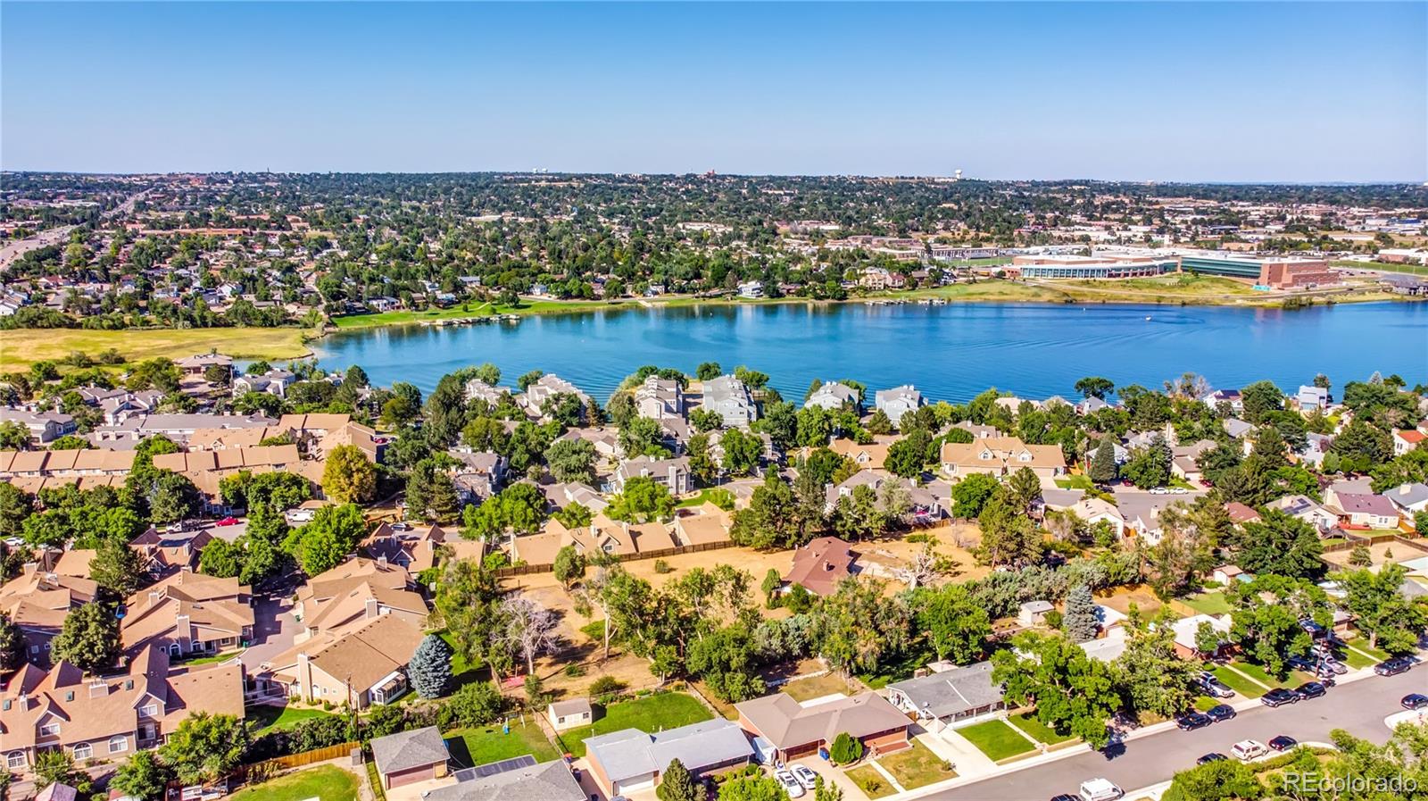 6766 Zenobia Loop Arvada, CO 80030 - Photo 28 of 38 an aerial view of a houses with a lake view