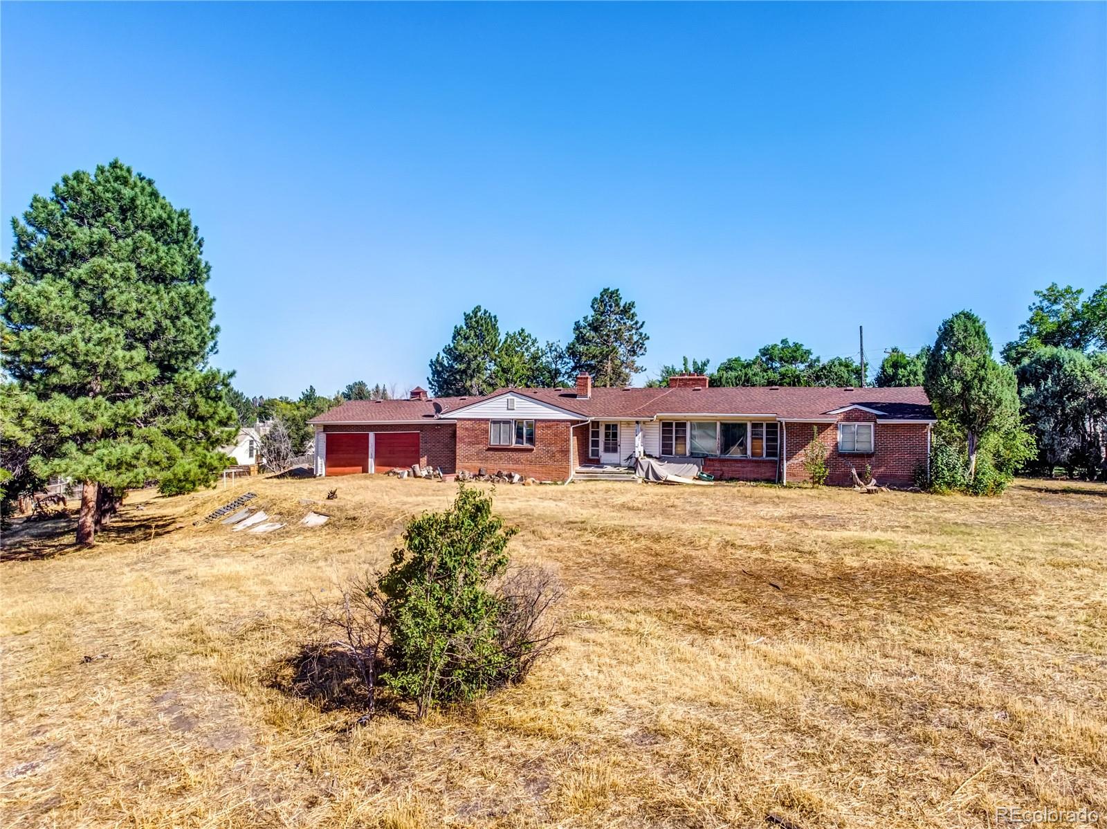 6766 Zenobia Loop Arvada, CO 80030 - Photo 3 of 38 a front view of a house with a yard