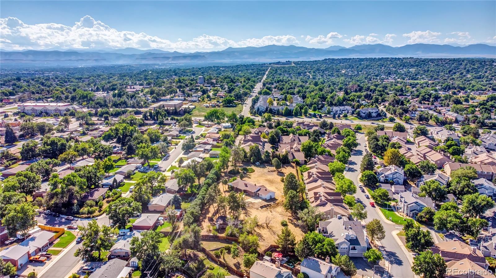 6766 Zenobia Loop Arvada, CO 80030 - Photo 32 of 38 a view of a city with mountains in the background