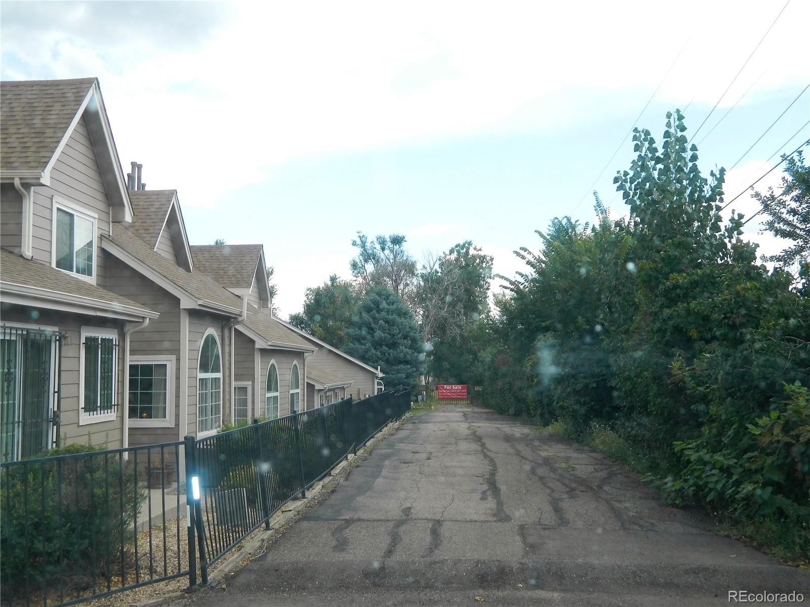 6766 Zenobia Loop Arvada, CO 80030 - Photo 36 of 38 a very nice looking house with a big yard and large trees