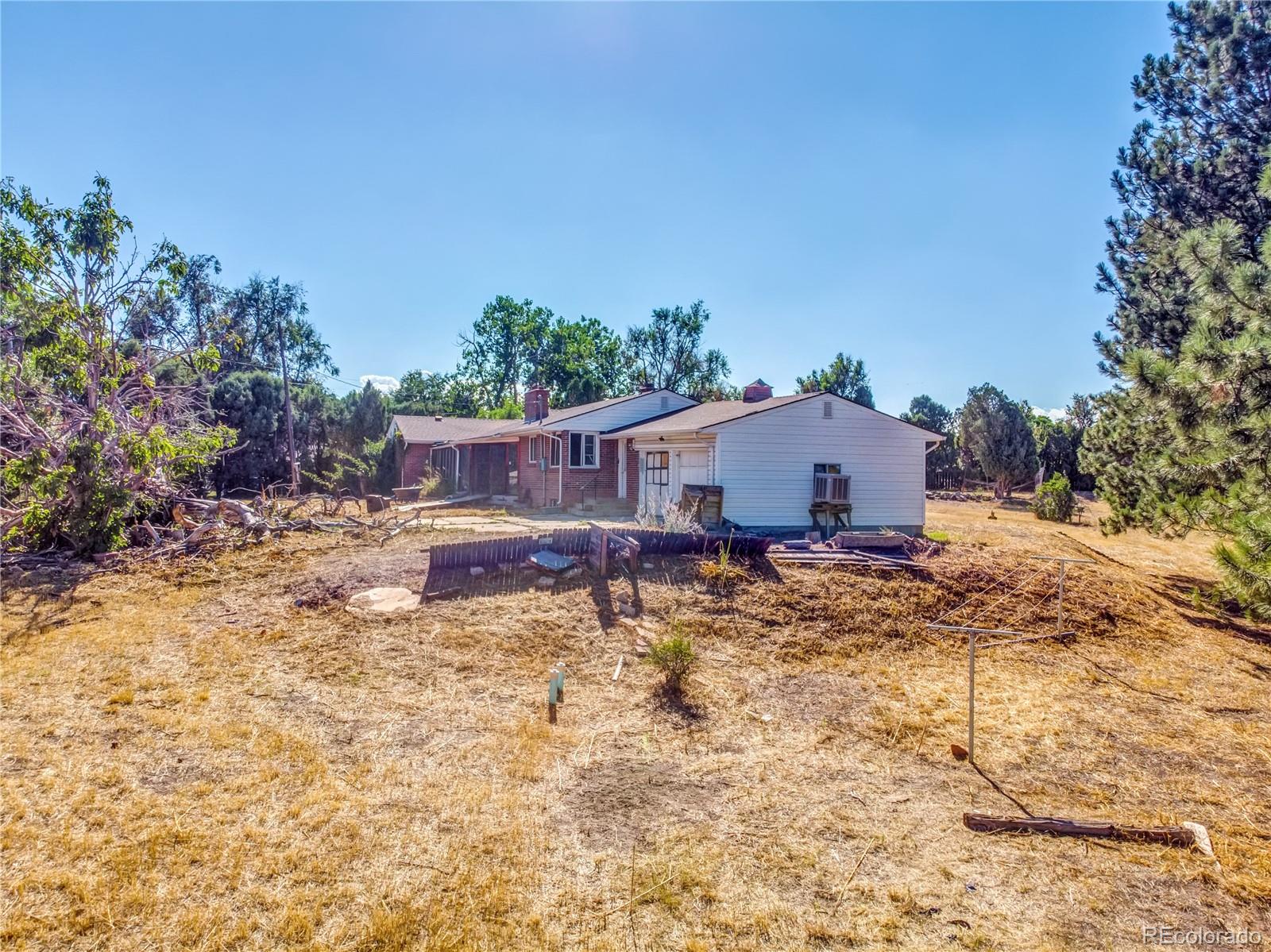 6766 Zenobia Loop Arvada, CO 80030 - Photo 5 of 38 a view of a house with a yard