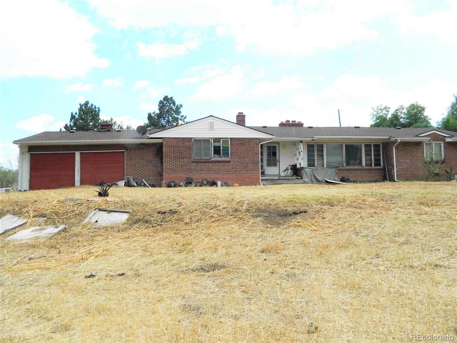 6766 Zenobia Loop Arvada, CO 80030 - Photo 9 of 38 a front view of a house with a yard covered with snow