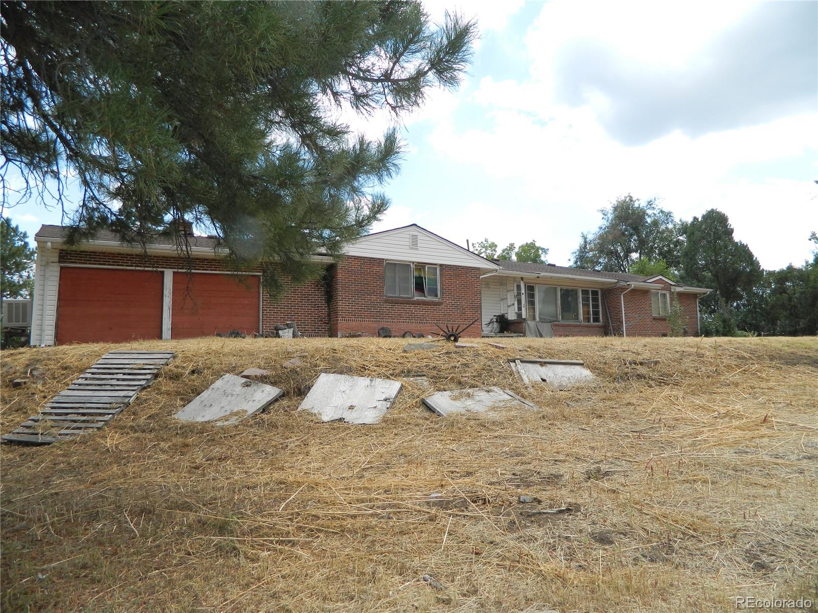 6766 Zenobia Loop Arvada, CO 80030 - Photo 10 of 38 a front view of house with yard and trees around