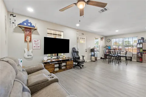 a living room with furniture and a flat screen tv
