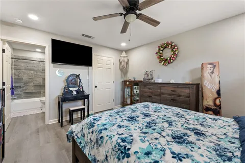 a bed room with a bed and a television