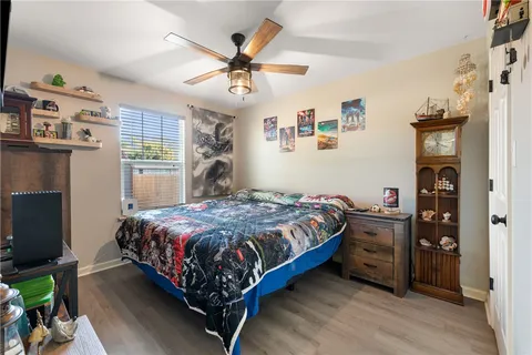 a bedroom with a bed dresser and a flat screen tv