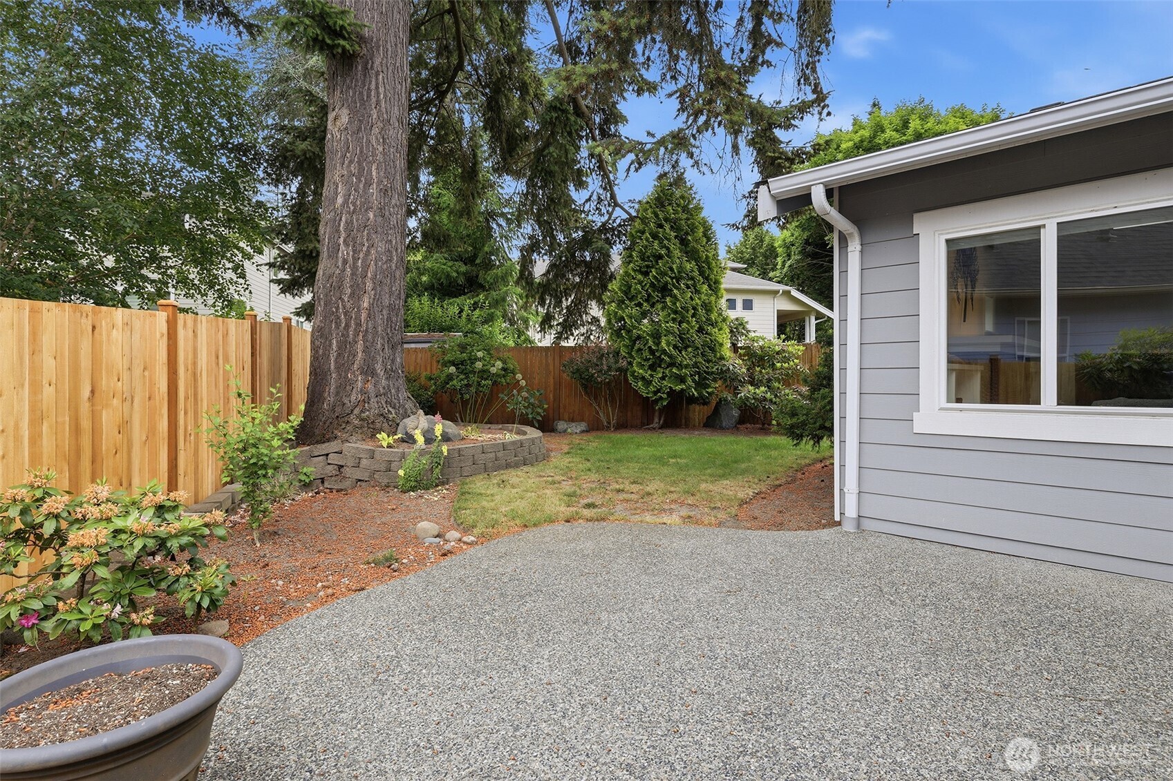 17747 89th Court Northeast Bothell, WA 98011 - Photo 16 of 33 a view of a backyard with potted plants and large tree