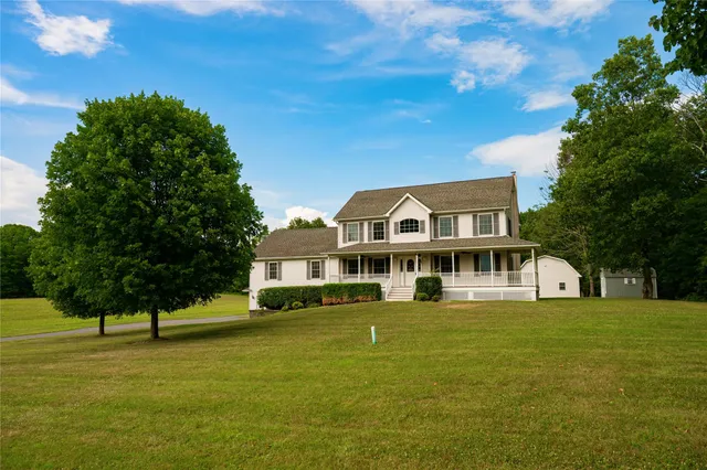 a front view of a house with a garden